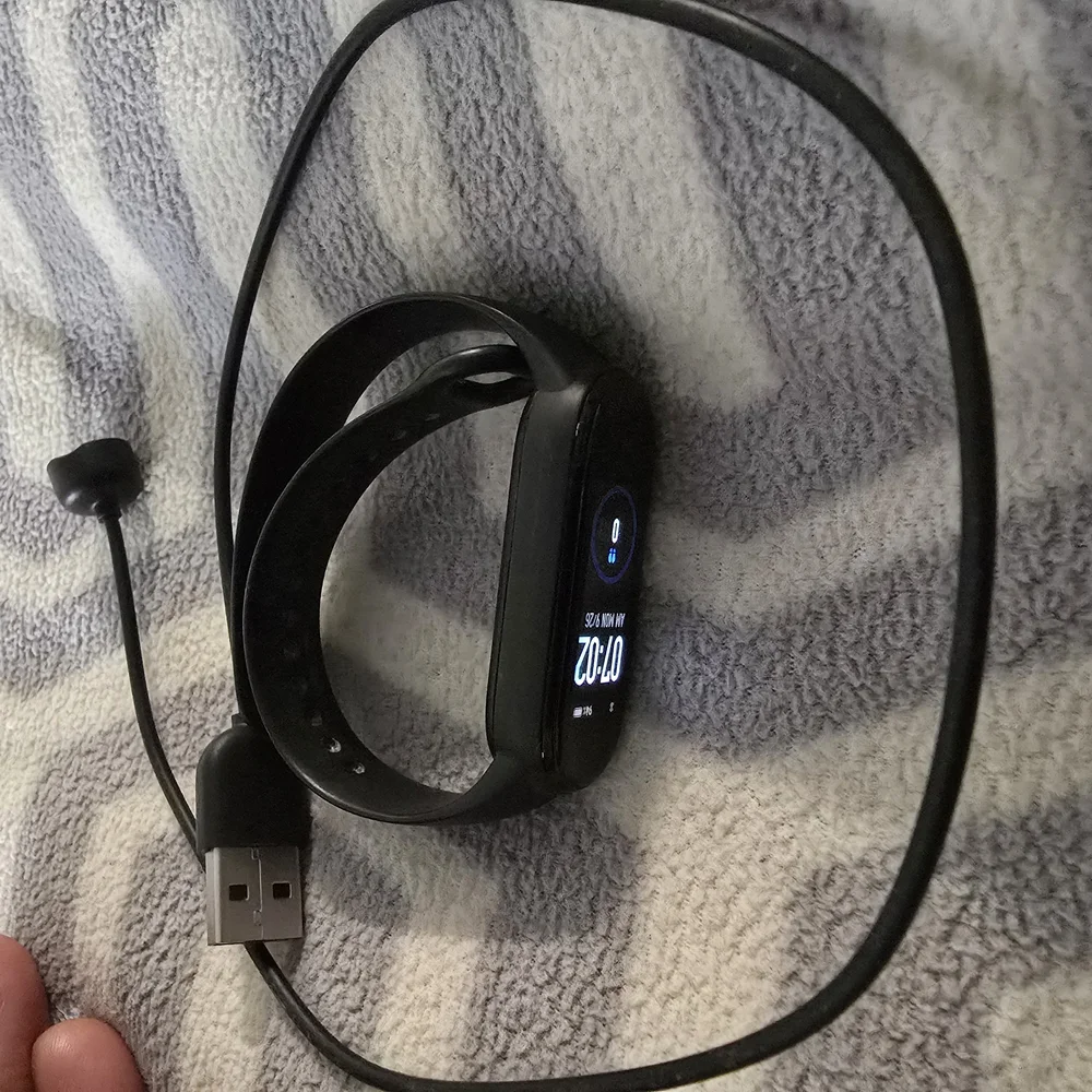 Smart Fitness Tracker with Black Band W/Charge Cable.
